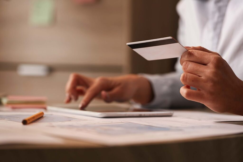 A man with a credit card calculates his income
