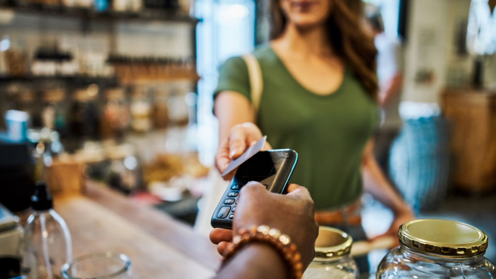 Woman Pays with Card in Shop