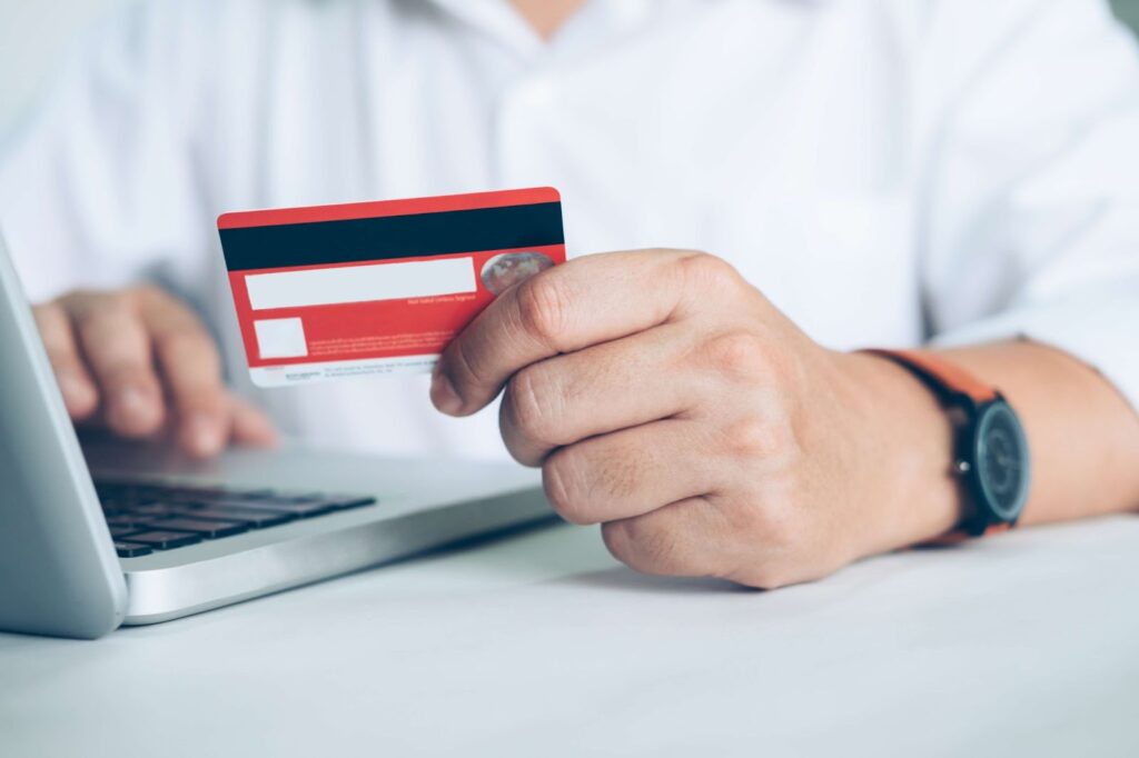 A man enters card details into a computer